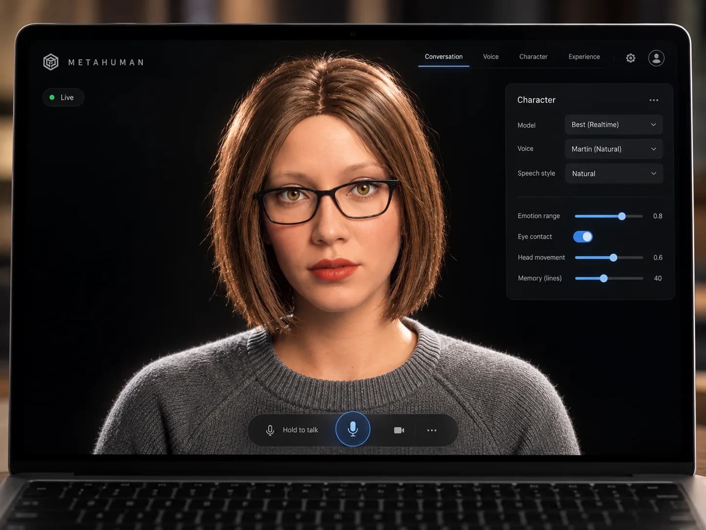 A laptop showing a realistic digital human with a bob haircut and glasses, a hold-to-talk bar beneath her and a character panel for model, voice, emotion range and eye contact.
