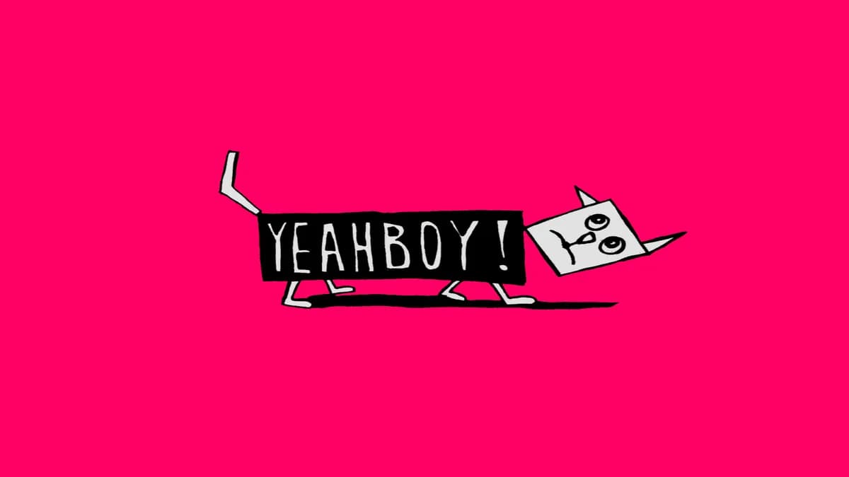 A white cat whose black body is a sign reading YEAHBOY!, on a flat pink ground.