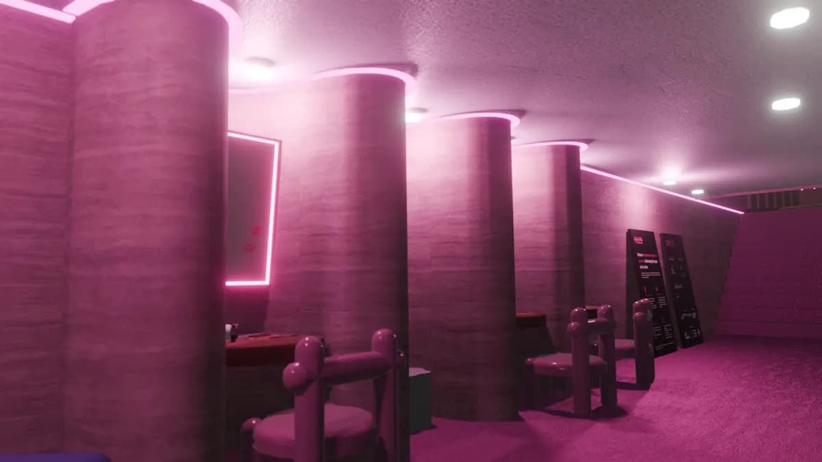 A pink room with round pillars, soft wall lights, and padded chairs.